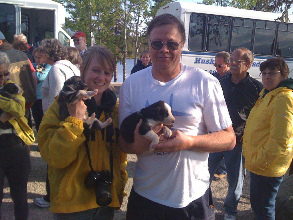 A man and woman holding two cats in their hands in color