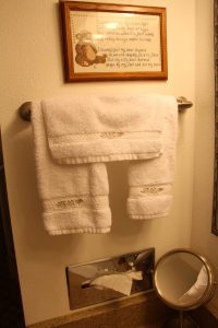 A towel rack with two towels hanging on it.