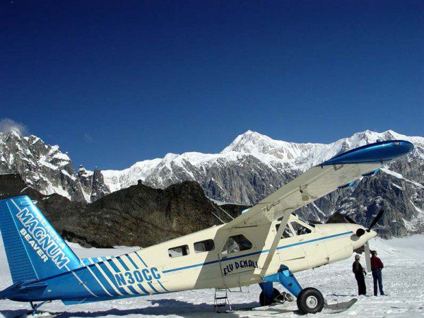 A small plane parked on top of snow covered ground image